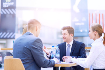 Group of happy young business people in a meeting at office