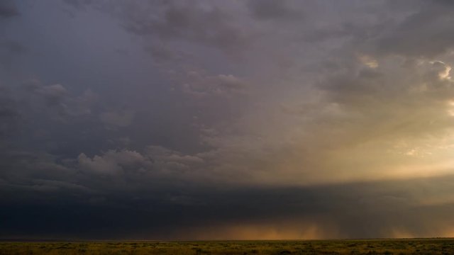 Rain clouds. Impressive thundercloud at dawn over the Russian steppe