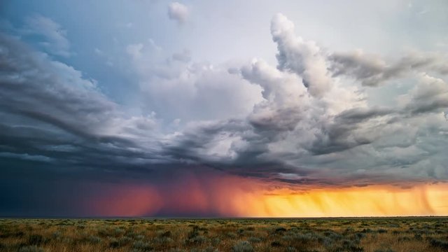Rain clouds. Impressive thundercloud at dawn over the Russian steppe

