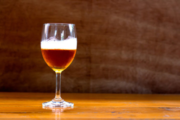Wine in a glass of wine on a wooden table.