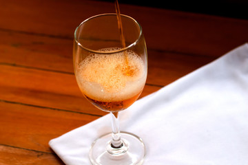 Wine in a glass of wine on a wooden table.
