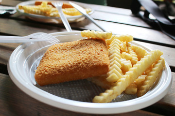 Unhealthy golden fried cheese with potato chips