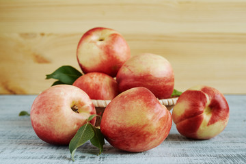 Several ripe nectarines on a wooden table
