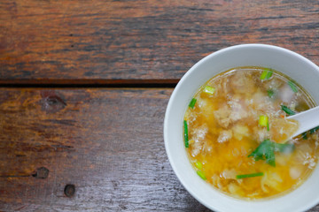 top view A boiled rice in a cup on a wooden table with copy space