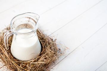 jug of milk on a wooden rustic table. copy space