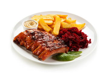 Grilled ribs, French fries and vegetables on white background