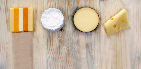 Four cheeses - variety, brie, smoked cheese, sliced cheese - & text space.
