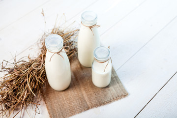 bottles of milk on a wooden rustic table.
