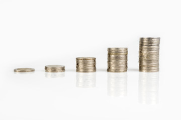 Savings, business growth, financial stability concept by several stacks of coins on white background.