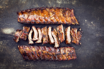Barbecue Pork Spare Ribs as top view on an old rusty metal sheet