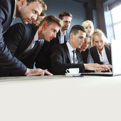 Fototapeta premium Business team look together at laptop