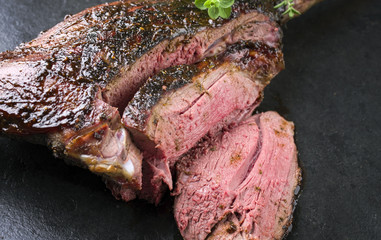 Barbecue Haunch of Venison with Marinade as close-up on a slate slab