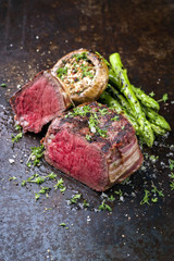 Barbecue Wagyu Point Steak with green Asparagus and Mushroom Cap as close-up on a rusty metal sheet
