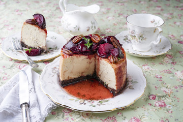 Traditional cheesecake with plum and pecan nut on plate