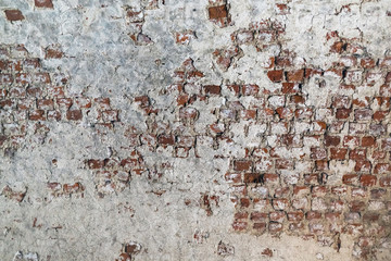 Old brick wall with peeling plaster. Grunge brickwork texture.