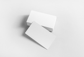Blank business cards on paper background. Mockup for branding identity. Studio shot.