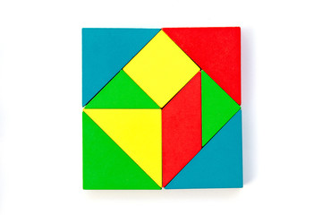 Wooden colorful toy block in multiple shape build to square design on white background