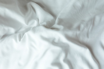 Obraz premium Top view of white bedding sheets after wake up in the morning