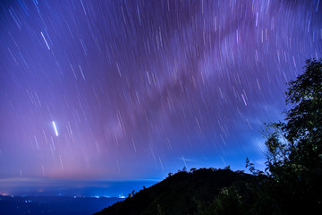 Beautiful spiral startrail at Den Chang Non Crest, Pha Peung, Pua, Nan, Thailand.  Fantastic star timelapse with mountain background.