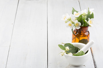 Spa concept - making essential oil with jasmine flowers