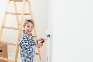 Kid painting a wall