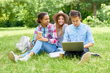 Group of  Happy Students Enjoying Break on  Lawn