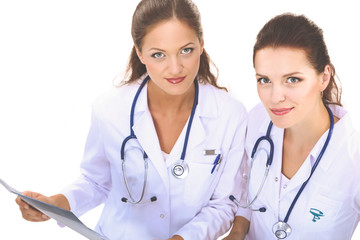 Beautiful young woman in white coat posing with hand in pocket. Woman doctor