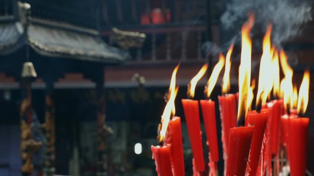 Candles at taoist shrine burning slowly