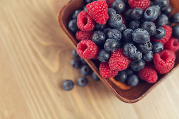 Blueberry and raspberry on a wooden table