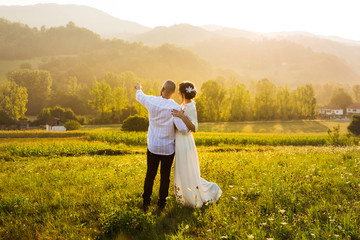 Couple enjoying sunset view in the field