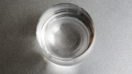 glass of water on silver plate