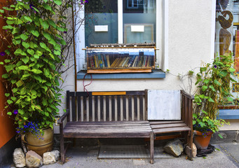 Fototapeta na wymiar A bench and a book shelf on the street in Erfurt, Germany