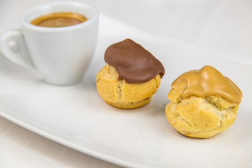 bignè and coffee on white dish