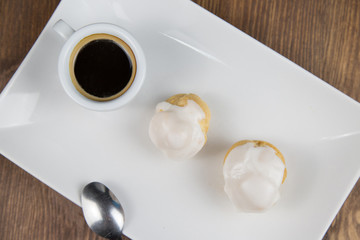 bignè and coffee on white dish