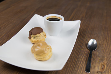 bignè and coffee on white dish