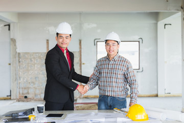 Two Businessmen or engineers shaking hands for agree to business together on their job site.