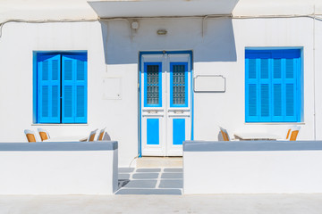 Front view of typical white house with blue windows in Mykonos town, Mykonos island, Greece