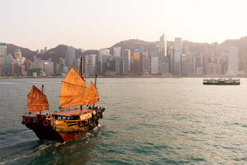 The Aqua Luna sail around Victoria Harbour during sunset twilight time in Hong Kong