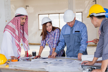 Harmonious Muslim engineer and technician team discussing in building construction site. Teamwork collaboration relation concept