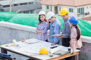 Harmonious engineer and technician team dicussing in building construction site. Teamwork collaboration relation concept