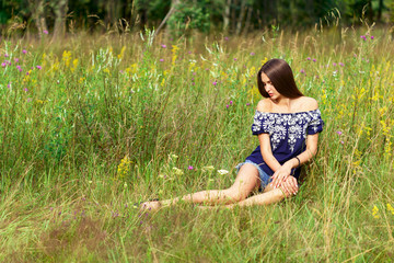 Beautiful woman enjoying daisy field, nice female lying down in the meadow of flowers, pretty girl relaxing outdoor, having fun, happy young lady and spring green nature, harmony and freedom concept