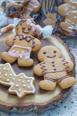 Sweet gifts for holiydays. Homemade christmas gingerbread cookies and caramel candies on a wooden board, vertical