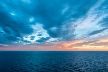 Naklejka na ściany i meble Sunset over the Mediterranean Sea off of the Cinque Terra Coast.