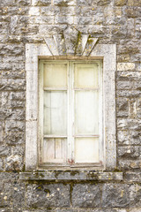 Fototapeta na wymiar old window on stone wall