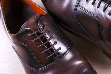 Male fashion with shoes on wooden background.