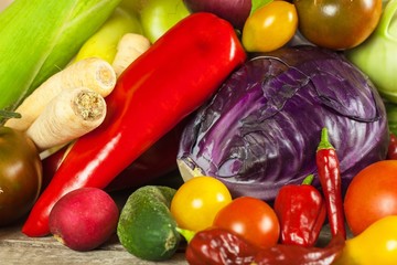 Different types of fresh vegetables on a wooden table. Harvesting vegetables on a farm. Healthy food.