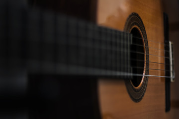 Acoustic guitar background, unusual view. Blurred photography, selective focus. Copyspace, perfect...