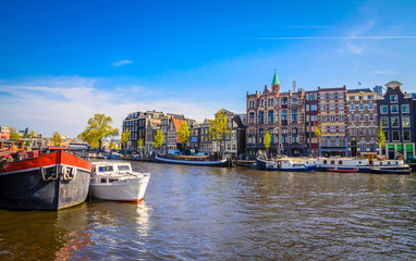 Fototapeta premium Traditional old buildings and and boats in Amsterdam, Netherlands. Canals of Amsterdam.