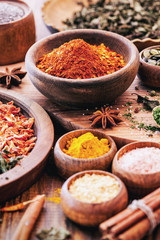 Spices and Herbs on Wooden Background