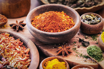 Spices and Herbs on Wooden Background